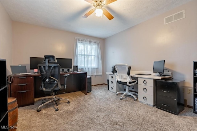 carpeted office space featuring ceiling fan and vaulted ceiling