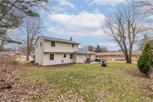 back of property featuring a lawn