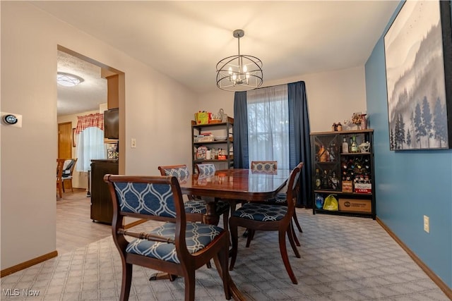 dining room with a notable chandelier