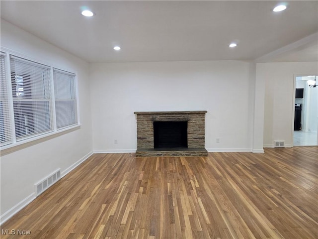 unfurnished living room featuring a fireplace and wood-type flooring