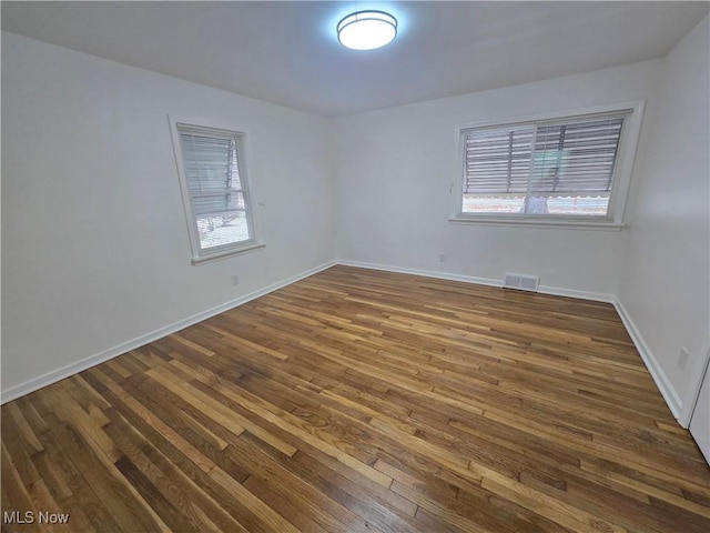 empty room featuring dark hardwood / wood-style floors