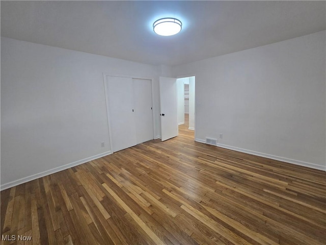 empty room with hardwood / wood-style flooring