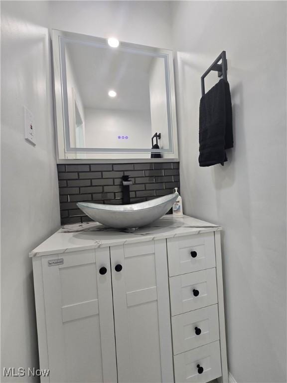 bathroom featuring tasteful backsplash and vanity