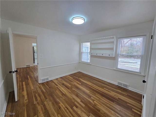 spare room with dark wood-type flooring