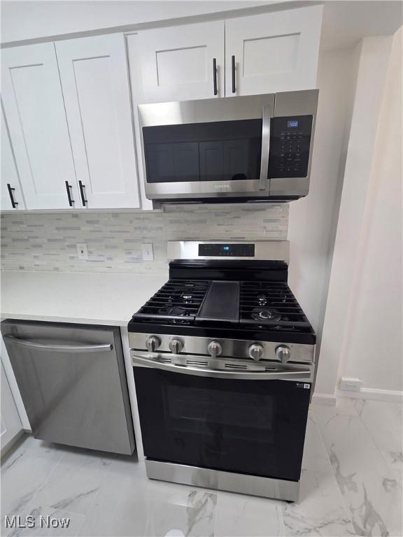 kitchen with white cabinetry and stainless steel appliances