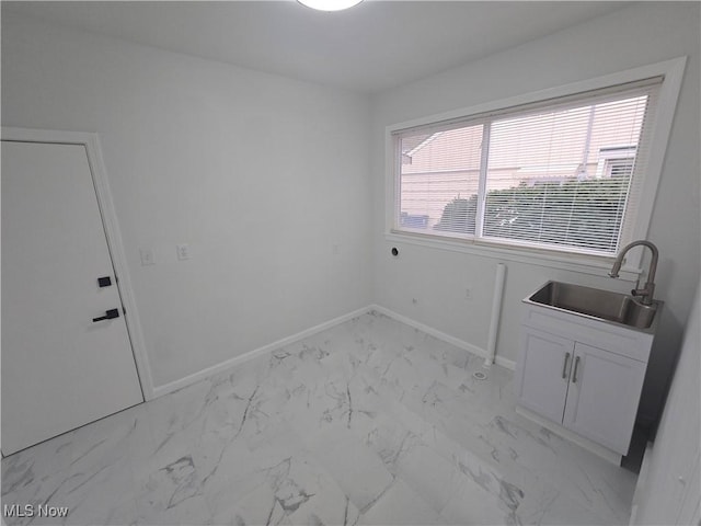 clothes washing area featuring cabinets, electric dryer hookup, and sink