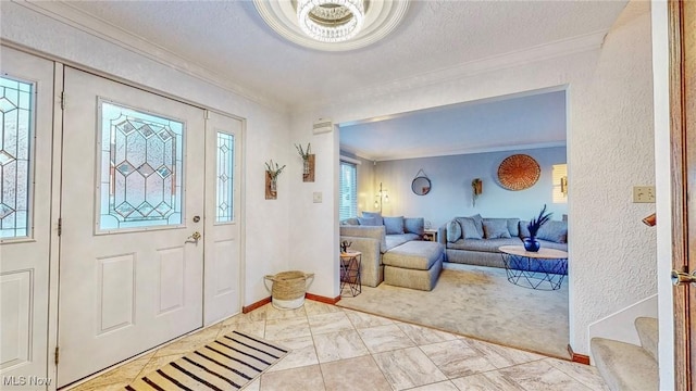 foyer entrance with ornamental molding and a textured ceiling