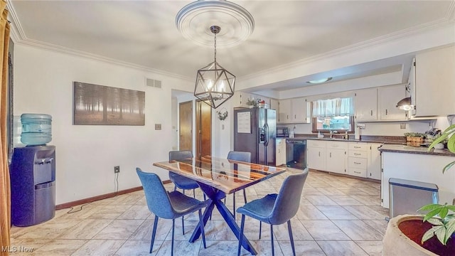 dining area featuring an inviting chandelier and ornamental molding