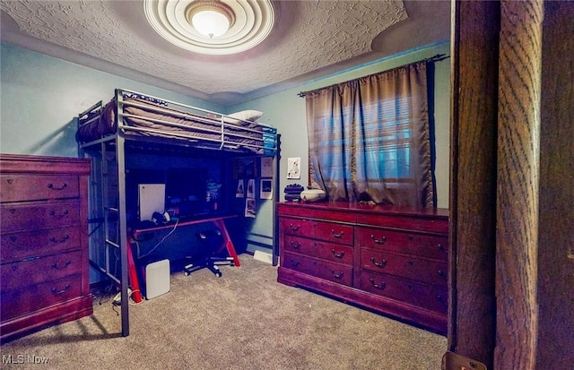 bedroom with carpet and a textured ceiling