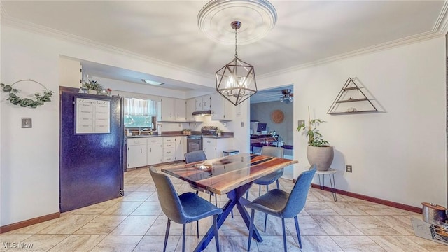 dining area featuring crown molding, a chandelier, and sink