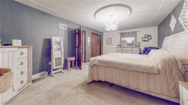 bedroom with light carpet, a chandelier, and a textured ceiling