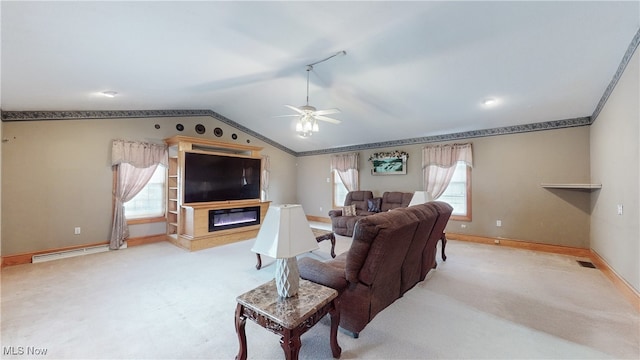 living room with baseboard heating, ceiling fan, vaulted ceiling, and light carpet