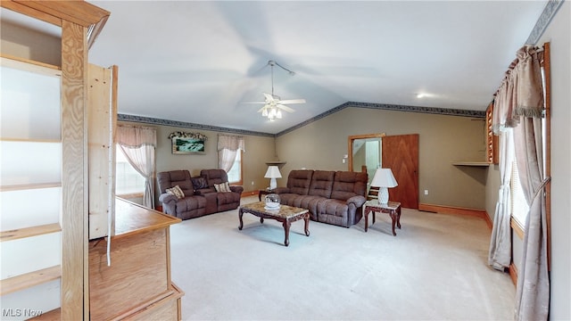 living room featuring ceiling fan, carpet floors, and vaulted ceiling