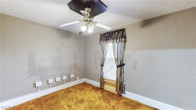 carpeted spare room with ceiling fan and a textured ceiling