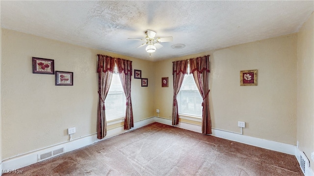 carpeted empty room with a textured ceiling and ceiling fan