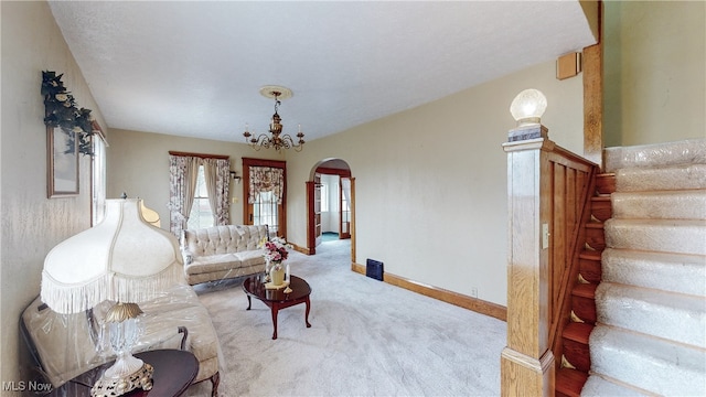 living room featuring a chandelier and carpet floors