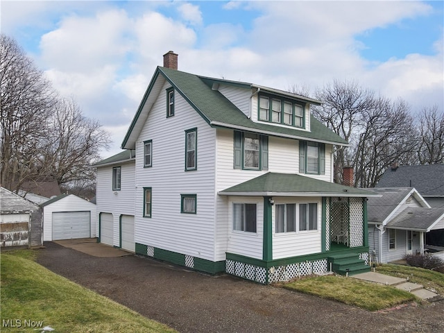 view of front of home featuring an outbuilding and a garage