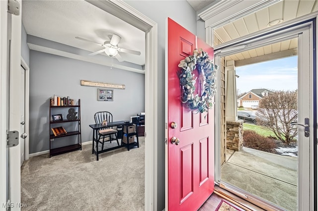 entryway featuring light colored carpet and ceiling fan