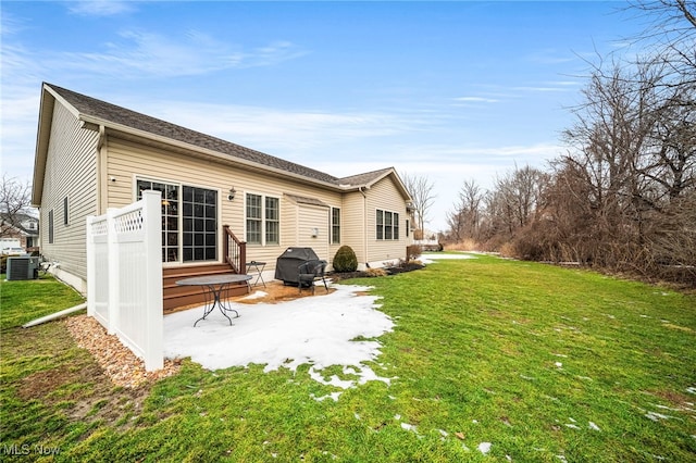 back of property with cooling unit, a yard, and a patio