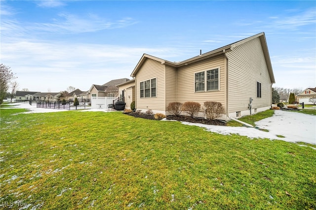 rear view of property with a yard