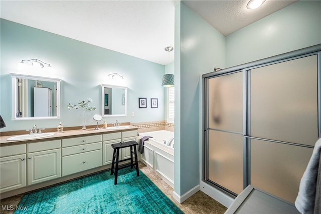 bathroom featuring vanity, shower with separate bathtub, and a textured ceiling