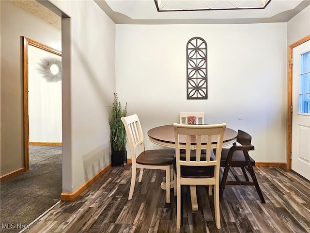 dining space featuring dark wood-type flooring