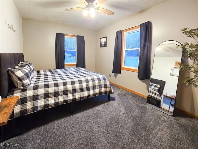 bedroom with ceiling fan, carpet, and a textured ceiling