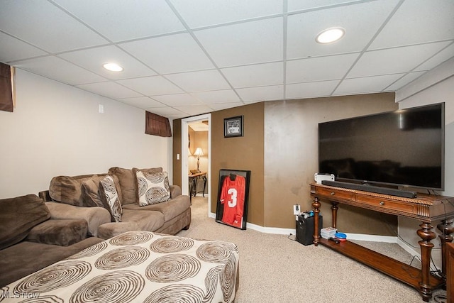 carpeted living room featuring a paneled ceiling