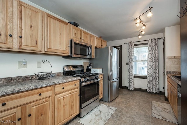 kitchen featuring light brown cabinetry, sink, and appliances with stainless steel finishes