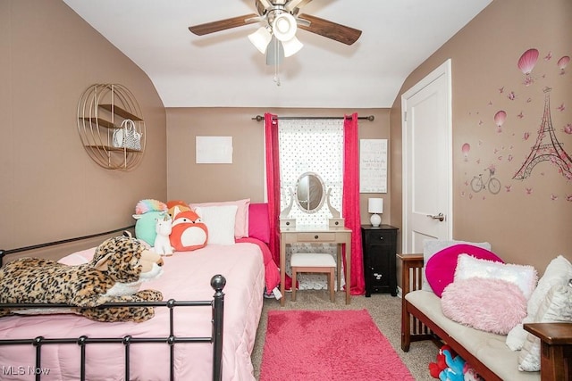 carpeted bedroom with ceiling fan and vaulted ceiling