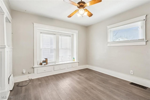 spare room with wood-type flooring and ceiling fan