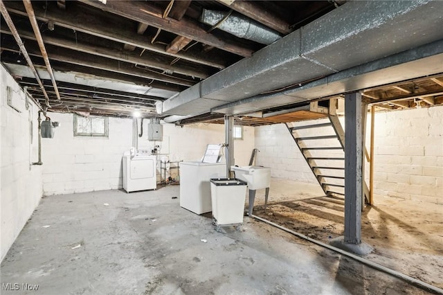 basement featuring electric panel and washer and dryer