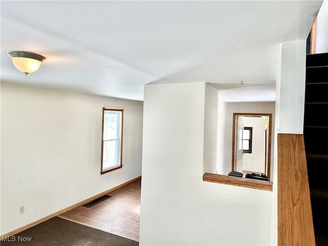 corridor featuring hardwood / wood-style floors