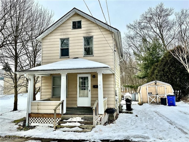 view of front of home featuring a storage unit