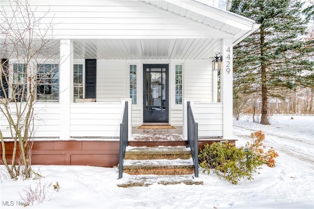 view of snow covered property entrance