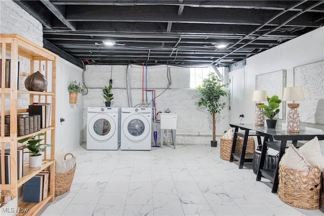 clothes washing area with washer and clothes dryer