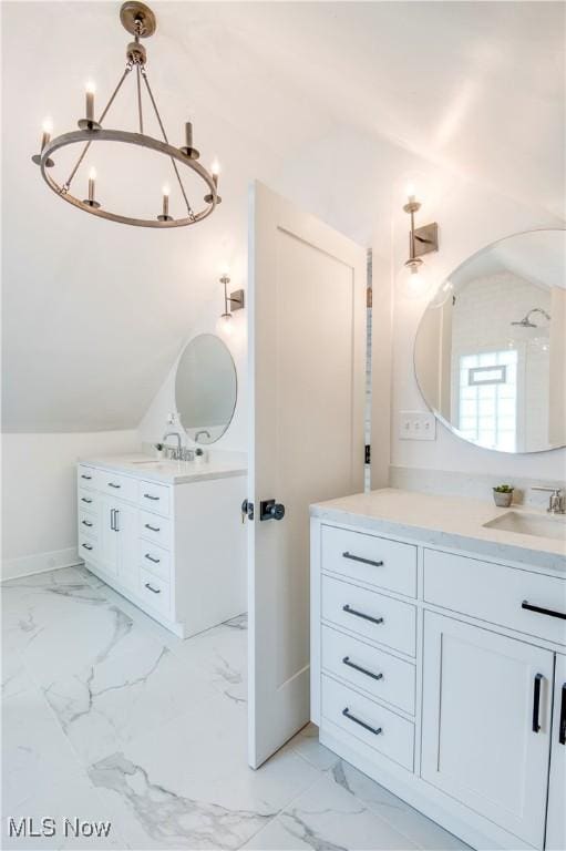 bathroom with vanity, lofted ceiling, and an inviting chandelier