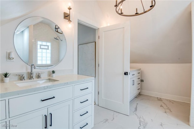 bathroom featuring lofted ceiling and vanity