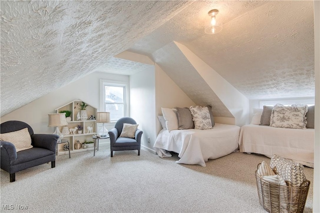 carpeted bedroom with lofted ceiling and a textured ceiling