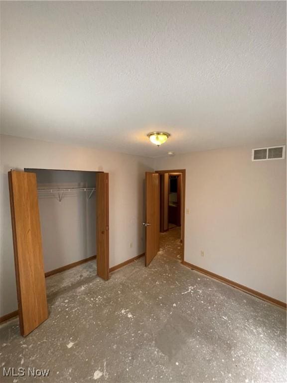 unfurnished bedroom with a closet and a textured ceiling