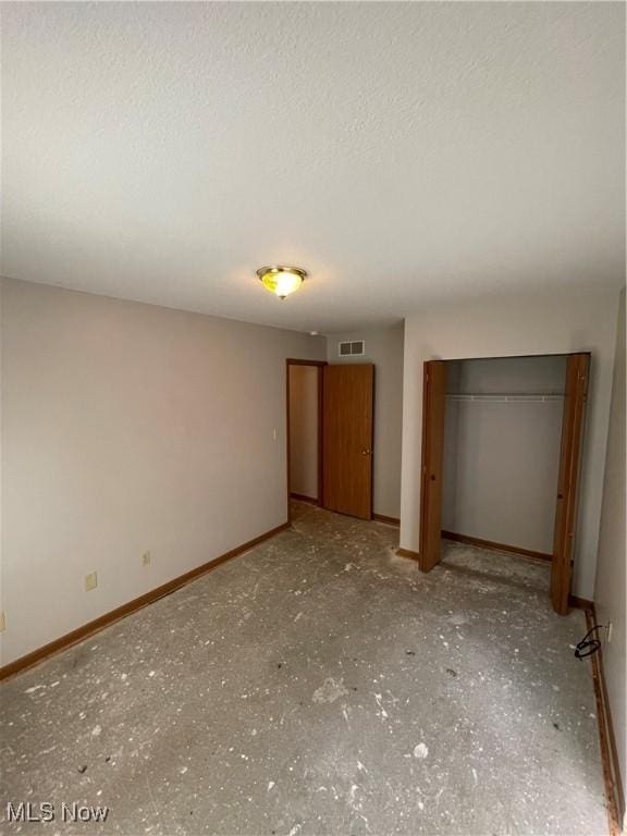 unfurnished bedroom with a closet and a textured ceiling