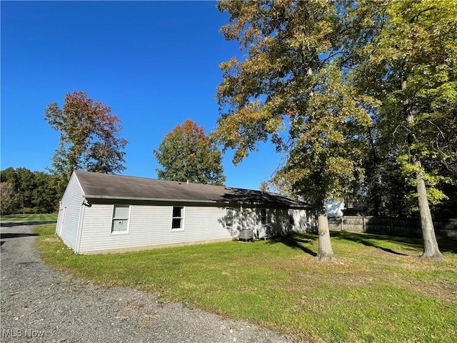 view of property exterior with a lawn