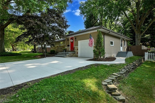 view of side of home featuring a garage and a yard