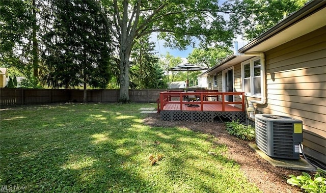 view of yard featuring central AC and a deck