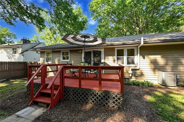 back of property with a wooden deck and central AC unit