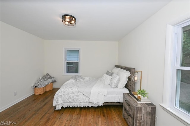 bedroom with dark hardwood / wood-style flooring