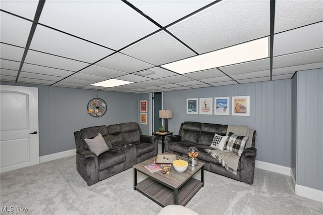 carpeted living room with a drop ceiling