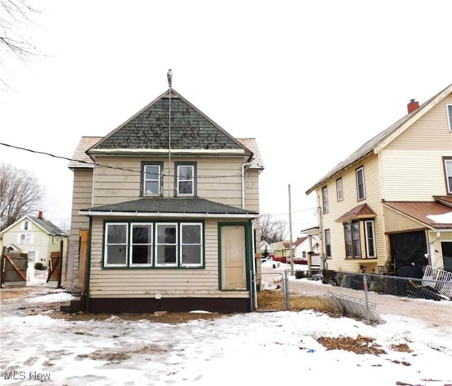 view of snow covered rear of property