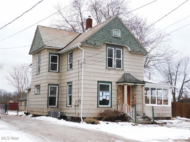 view of front of house featuring a sunroom and central air condition unit