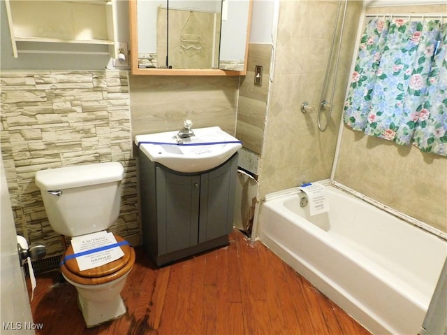 bathroom featuring vanity, wood-type flooring, and toilet